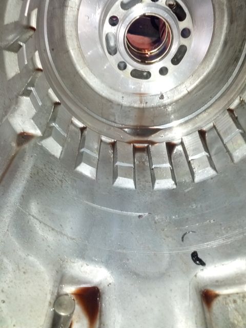 1995 Ford Bronco - Interior view of a transmission torque converter housing, showing internal splines and fluid residue.