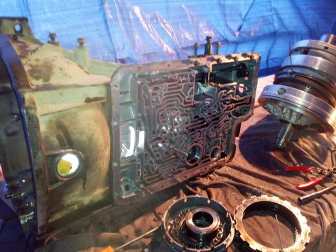 1995 Ford Bronco - Automatic transmission components are laid out on a cloth surface, revealing intricate internal parts.