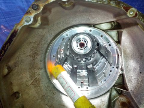 1995 Ford Bronco - A flashlight illuminates the intricate internal workings of a transmission torque converter.
