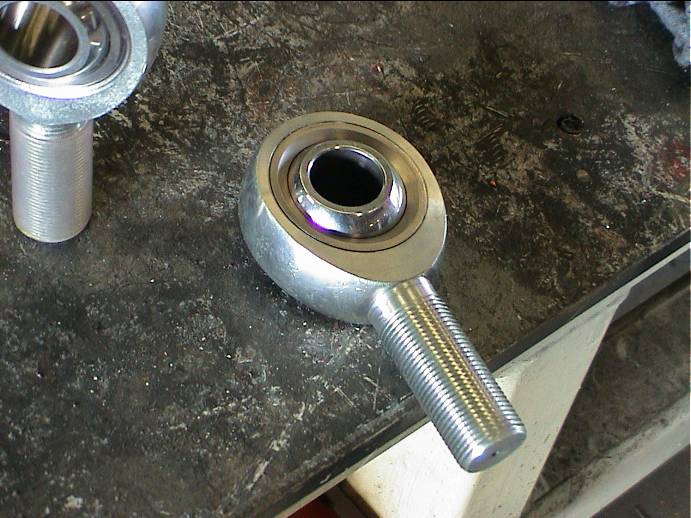 Rod end bearing with threaded shank on a workbench
