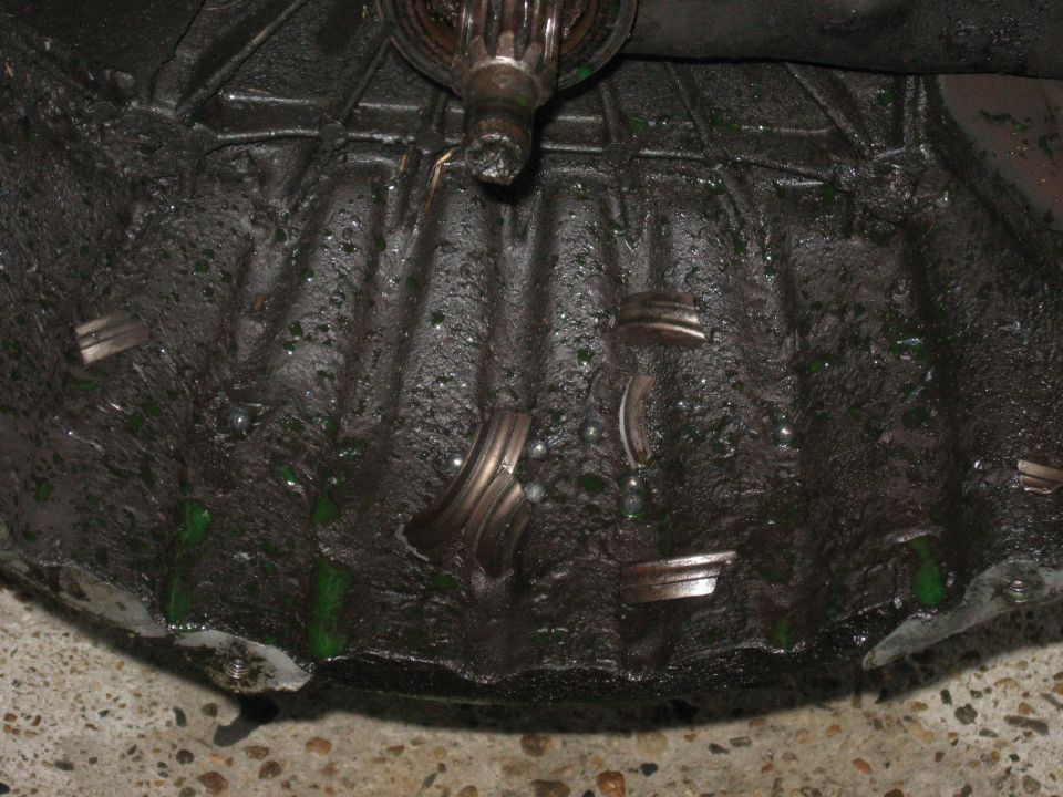 Transmission bell housing with green fluid and metal debris