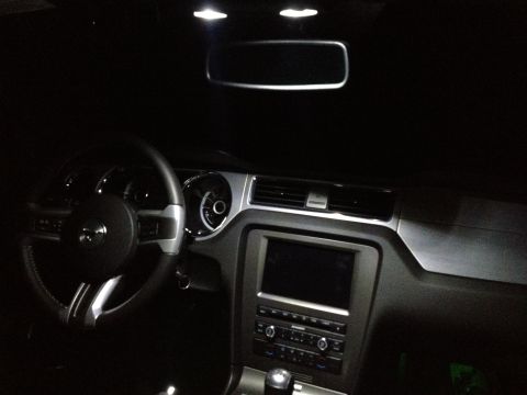2013 Ford Mustang - The interior of a 2013 Ford Mustang is illuminated by overhead lights.