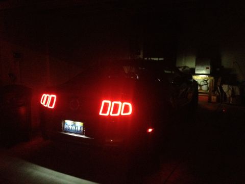 2013 Ford Mustang - Rear view of a 2013 Ford Mustang showing its distinctive illuminated taillights.