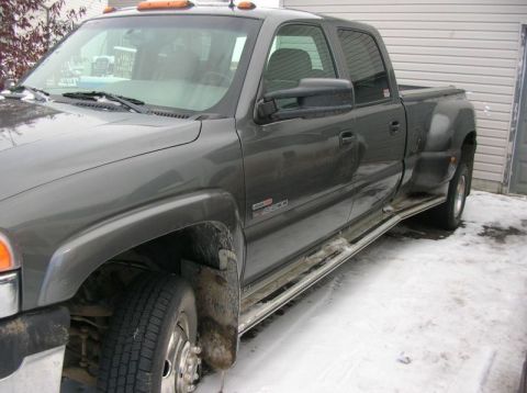 2001 GMC Sierra 3500 - This GMC Sierra 3500 dually pickup truck is shown from a 3/4 front angle in a snowy environment.