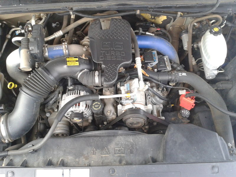 GM 6.6 Duramax turbo diesel V8 engine bay with intake, alternator and tank