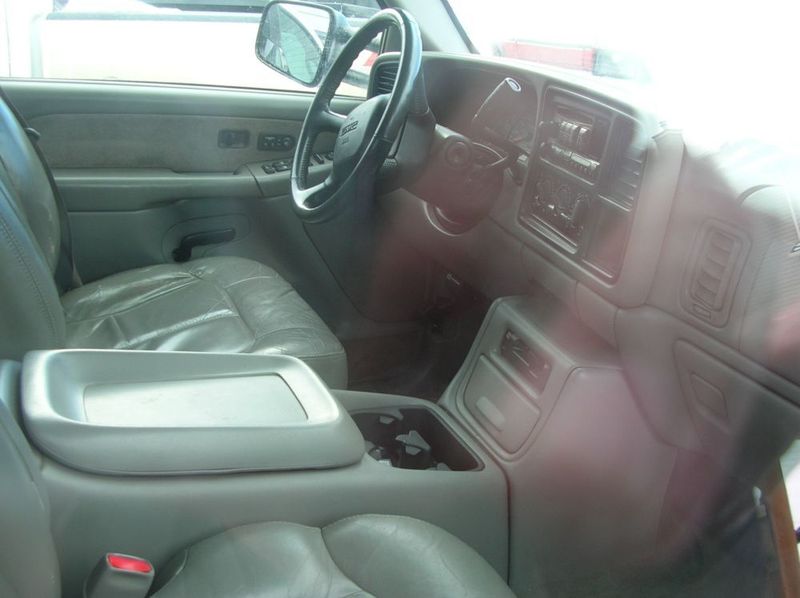 Gray leather interior of a 2001 GMC Sierra 3500, showing the dashboard, steering wheel, center console, and seats