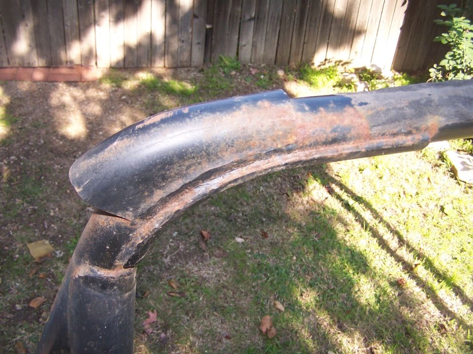 rusted black metal bar with a curved section