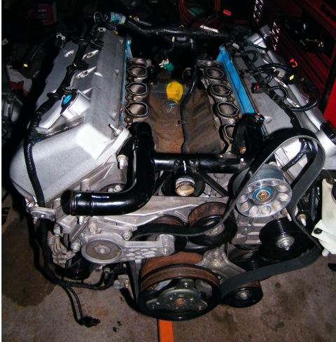 2004 Ford Crown Victoria - Engine assembly with V-shaped cylinder banks and exposed intake ports, likely a Ford modular engine.