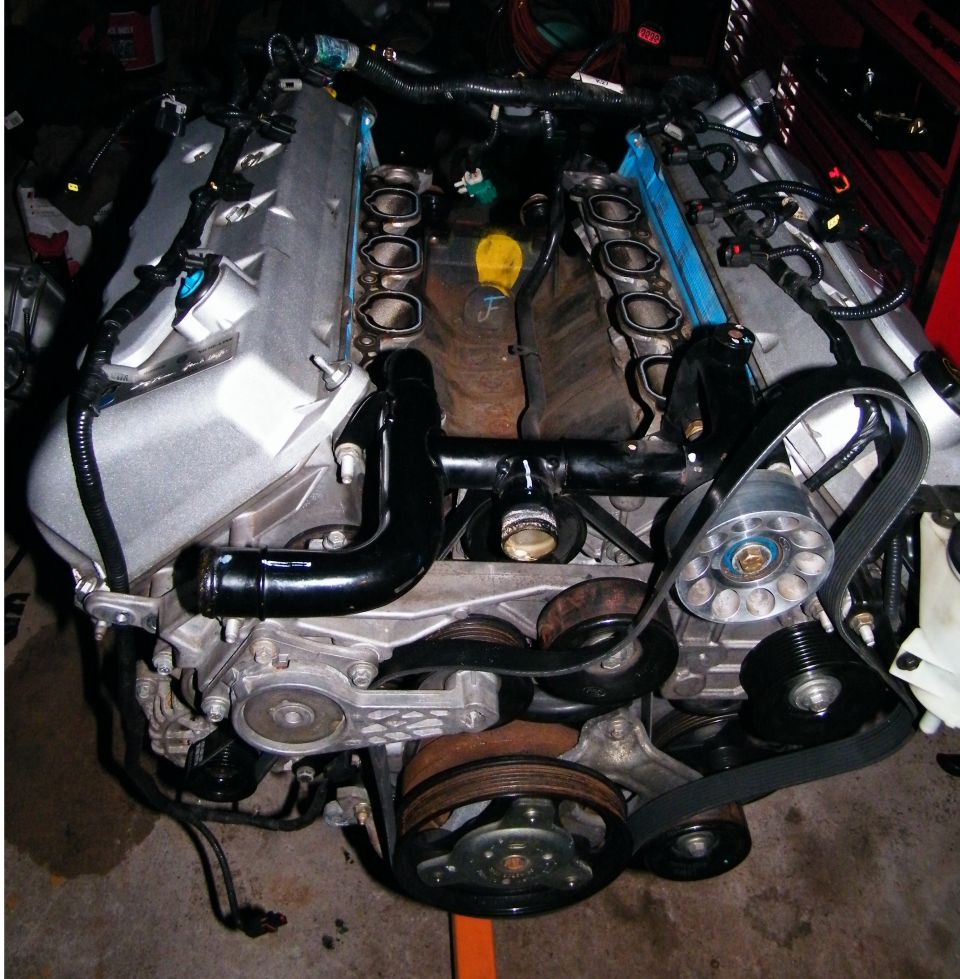 Engine assembly with V-shaped cylinder banks and exposed intake ports