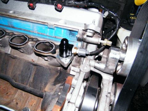 2004 Ford Crown Victoria - Close-up view of an engine component with a black sensor and wiring attached.