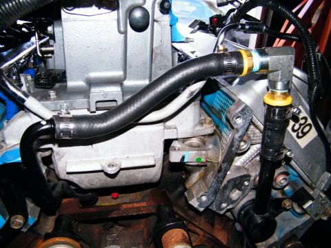 2004 Ford Crown Victoria - Engine bay detail showing hoses and metal parts, with a visible sticker labeled '39'.