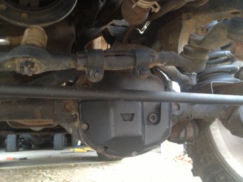 2000 Jeep TJ - The underside of a vehicle shows a WARN differential cover and steering components.