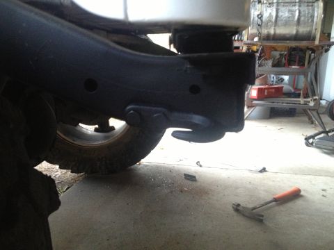 2000 Jeep TJ - Close-up view of a vehicle's frame, showing a tow hook and part of a tire.