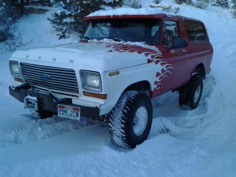 1979 Ford Bronco - Ford Bronco with flame decals driving in the snow.