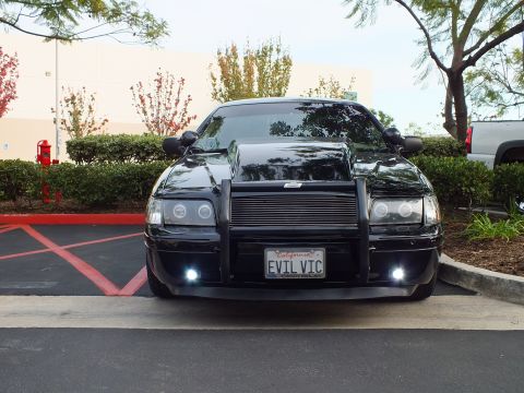 2003 Ford Crown Victoria - Blacked-out Crown Victoria showing billet grille, brush guard and glowing white auxiliary lamps.