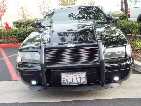 2003 Ford Crown Victoria - Front of a blacked-out Crown Victoria with halo headlights and a CROWN VICTORIA plate frame.