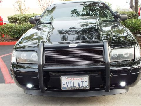 2003 Ford Crown Victoria - Blacked-out Crown Victoria sedan with billet grille, brush guard and CROWN VICTORIA plate frame.