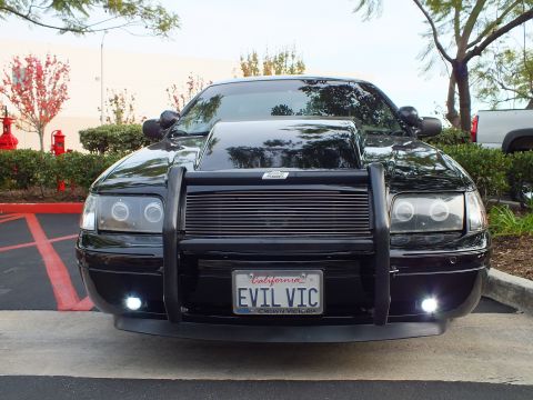 2003 Ford Crown Victoria - Front of a black Crown Victoria with halo projector headlights and a CROWN VICTORIA plate frame.