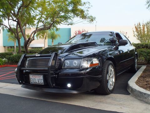 2003 Ford Crown Victoria - Angled view of a lowered blacked-out Crown Victoria with push bar, halo headlights and EVIL VIC plate.