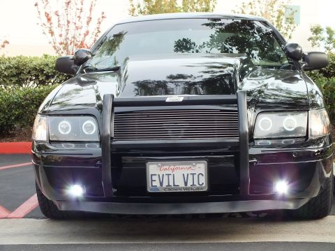 2003 Ford Crown Victoria - Blacked-out Ford sedan head-on, grille guard and EVIL VIC California tag with Crown Victoria frame.