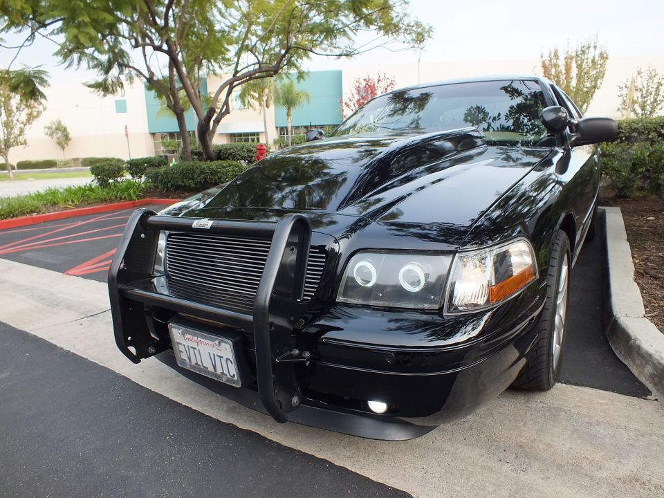 Black Crown Victoria front three-quarter with billet grille, halo lights and EVIL VIC plate