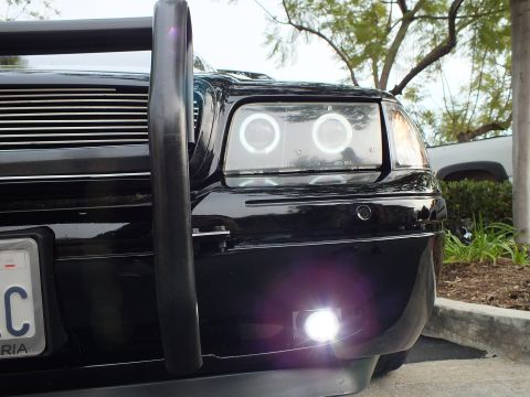 2003 Ford Crown Victoria - Detail of Crown Victoria front corner with twin halo rings, billet grille and bright white foglight.