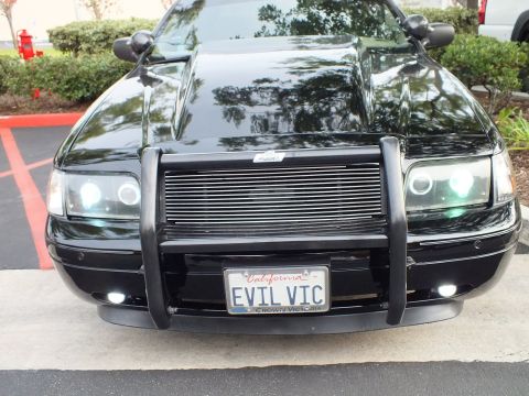 2003 Ford Crown Victoria - Front view of a lowered Crown Victoria, push bar around billet grille, halo lamps and white foglights lit.