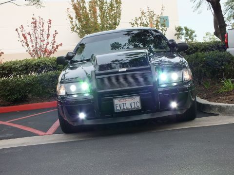 2003 Ford Crown Victoria - Lowered black Crown Victoria, projector halos and billet grille, custom grille guard, lot setting.