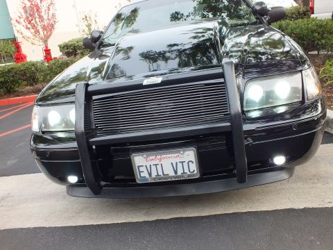 2003 Ford Crown Victoria - Low front-quarter shot of a black Ford Crown Victoria with billet grille and California EVIL VIC license plate.
