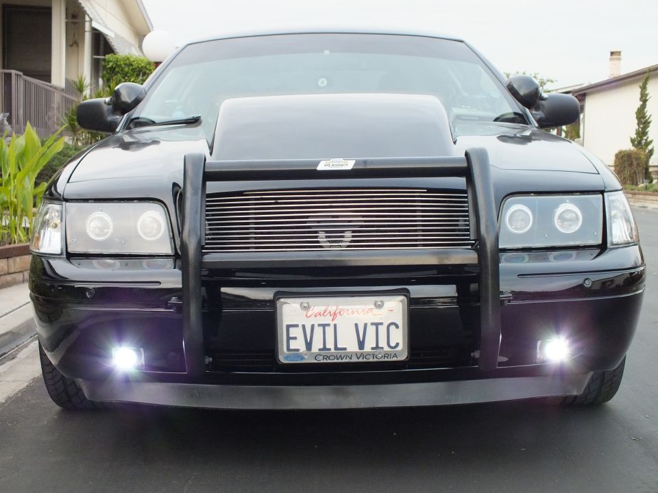 Black Crown Victoria front with billet grille, halo lights and lit fog lamps, EVIL VIC plate
