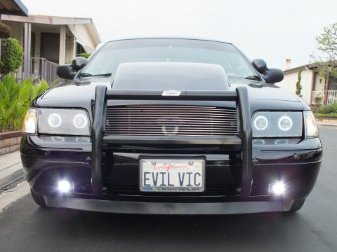 2003 Ford Crown Victoria - Black Crown Victoria shot head-on showing halo projector headlights, billet grille and EVIL VIC plate.