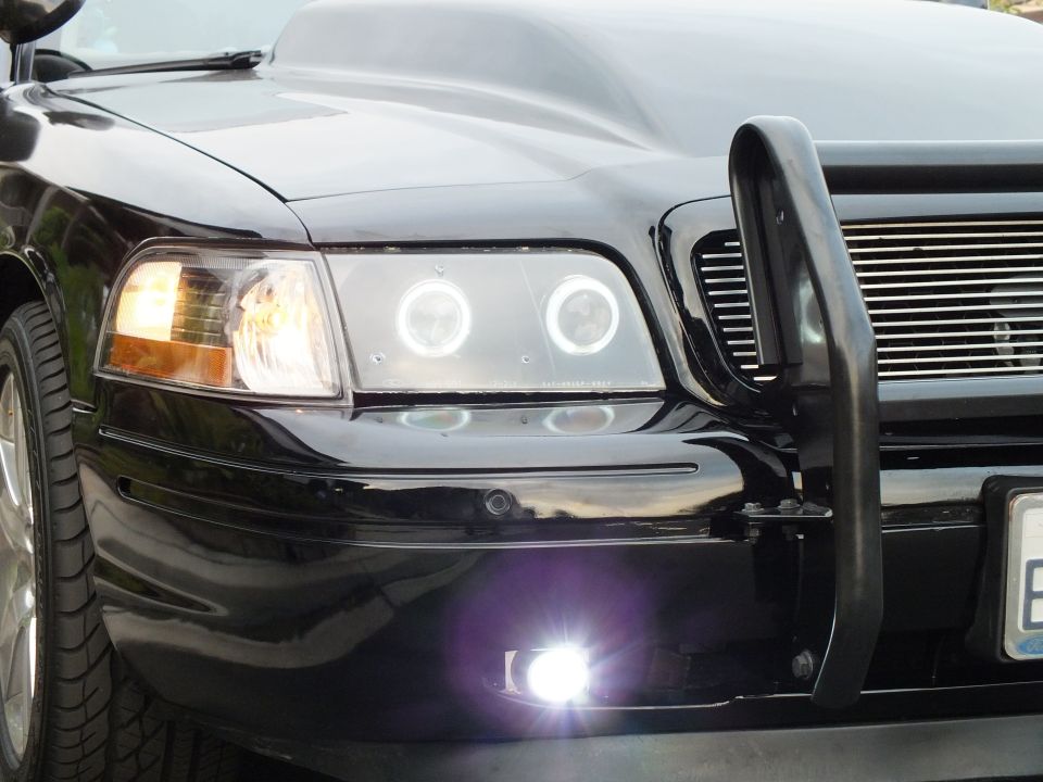 Black Ford Crown Victoria projector headlight with dual halo rings and black push bar