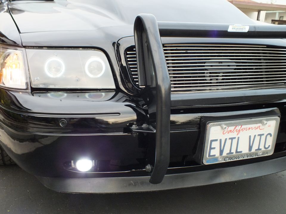 Black Crown Victoria front corner with EVIL VIC California plate and chrome billet grille