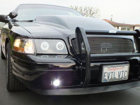 2003 Ford Crown Victoria - Customized Crown Victoria viewed from the front corner, halo headlight and billet grille glowing in low light.