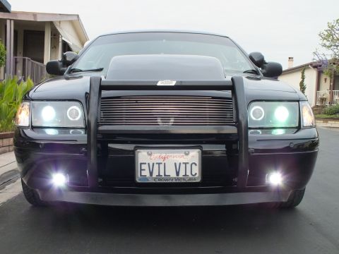 2003 Ford Crown Victoria - Symmetrical front shot of a Crown Victoria with glowing halo rings, fog lamps and chrome billet grille.