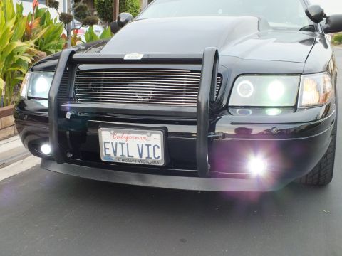 2003 Ford Crown Victoria - Front view of a modified Crown Victoria showing chrome billet grille, push bar and bright fog lamp flares.