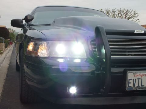 2003 Ford Crown Victoria - Low dusk shot of a black Crown Victoria with glowing headlights, fog lamp and EVIL VIC California plate.