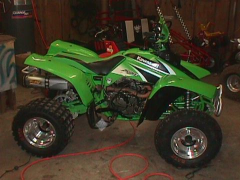 1980 Ford Bronco - A green Kawasaki ATV is parked inside a garage, with other recreational vehicles visible.
