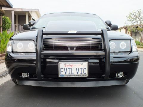 2003 Ford Crown Victoria - Symmetrical front view of a black Crown Victoria showing the EVIL VIC plate and billet grille.