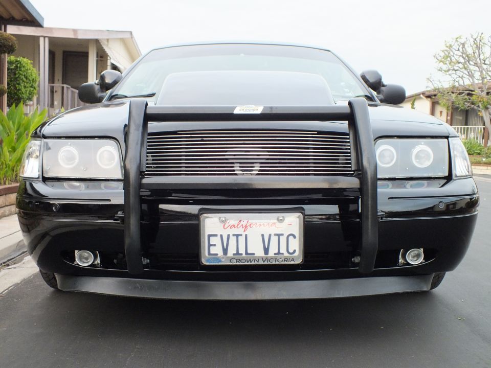 Black Ford Crown Victoria front with grille guard, halo headlights and EVIL VIC plate