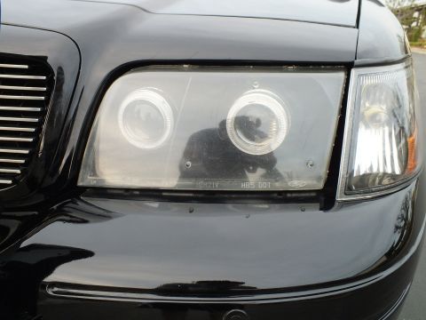 2003 Ford Crown Victoria - Close-up of a custom halo projector headlight with visible HB5 DOT lens markings.