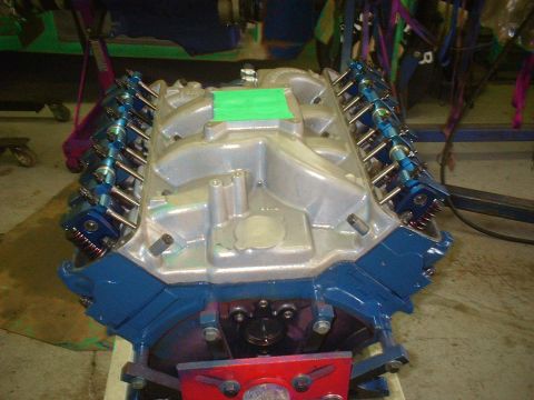 1971 Ford Ranchero - A V8 engine with blue accents and a silver intake manifold is displayed on a stand.