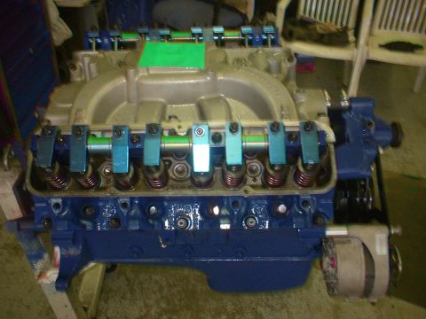1971 Ford Ranchero - Close-up view of a V8 engine, painted blue with chrome valve covers and a green intake manifold.