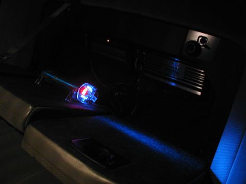 1998 Ford Taurus - Aftermarket lighting illuminates the interior of a car, highlighting an audio amplifier.