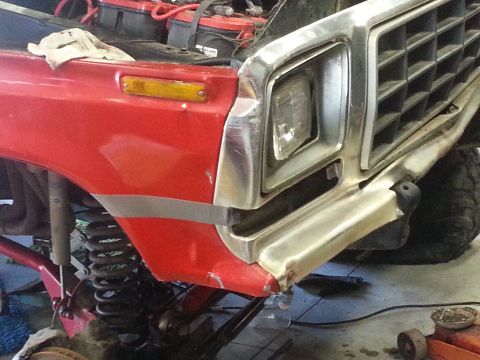 1978 Ford Bronco - Front view of a 1978 Ford Bronco, a red fender and chrome grille with visible damage.