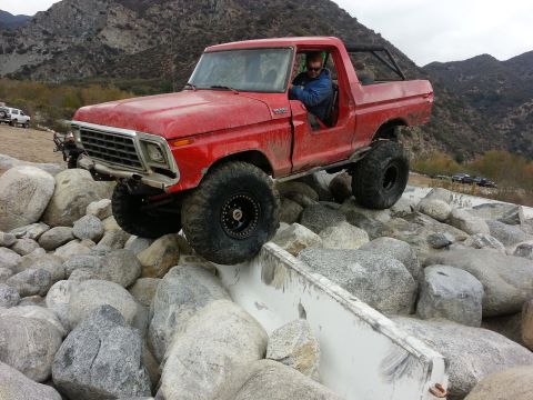 1978 Ford Bronco - This 1978 Ford Bronco is tackling a challenging off-road course with large boulders.