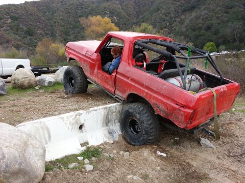 1978 Ford Bronco - A modified 1978 Ford Bronco navigates an obstacle course with a driver inside.