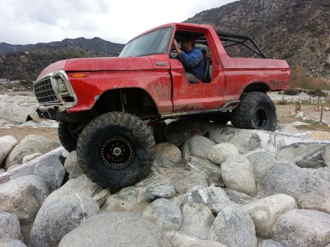 1978 Ford Bronco - This red 1978 Ford Bronco is navigating a challenging rocky terrain.