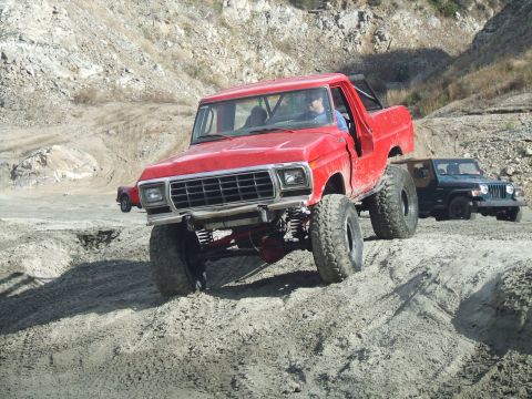 1978 Ford Bronco - Modified 1978 Ford F-150 pickup truck navigates a dirt trail, with another vehicle visible behind it.