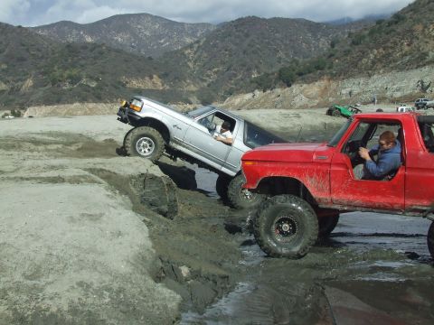 1978 Ford Bronco - Two Ford Broncos tackle a challenging muddy off-road course, their capabilities in difficult terrain.